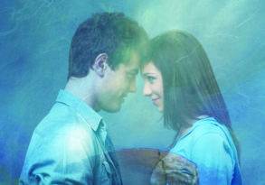 A dreamy image of a man and a woman close together, their foreheads touching, surrounded by a soft, blue smoky effect, radiating a sense of deep gratitude.