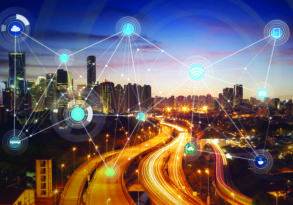 Digital network icons superimposed over a twilight cityscape with illuminated highways, highlighting smart cities.