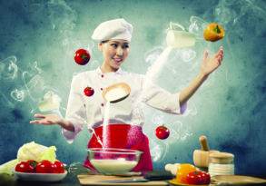 A female chef in a white uniform expertly juggles ingredients in a kitchen showcasing culinary innovation, with vegetables and milk floating around her.