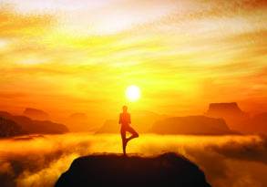 A person practicing yoga on a cliff during a breathtaking sunset with vibrant skies and mist over distant mountains, embodying a peace practice for inner peace.