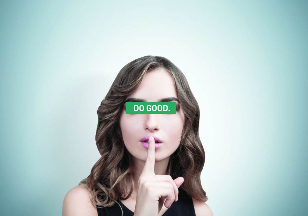 woman's face with finger near the lips and sign "DO GOOD" on the eyes