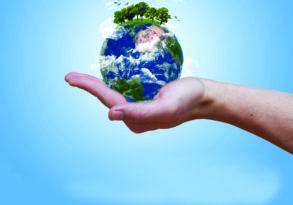 A hand holding a globe with trees sprouting from the top, set against Earth's atmosphere.