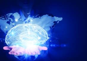 A digital image of a person holding a glowing brain with a world map backdrop, symbolizing global creativity and innovation.