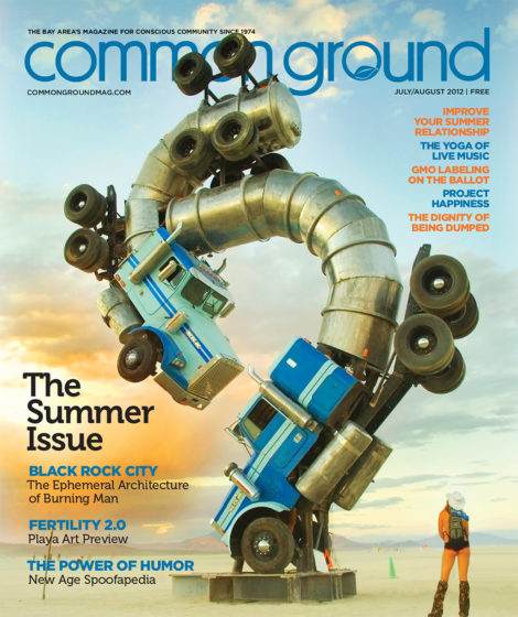 Magazine cover featuring a surreal desert landscape with a man walking toward large stacked, colorful vintage televisions under a bright blue sky in July 2012.