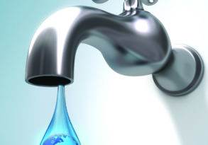 A chrome faucet with a drop of water containing an image of earth, symbolizing sustainable water use, against a light blue background.