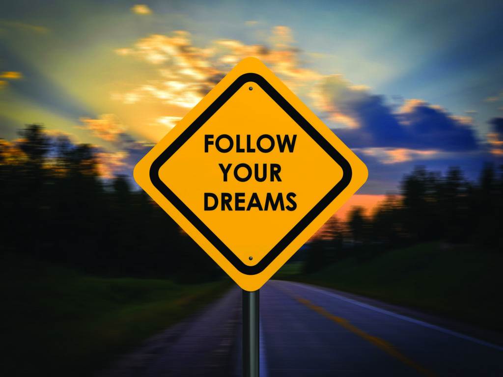 road sign "Follow Your Dreams"