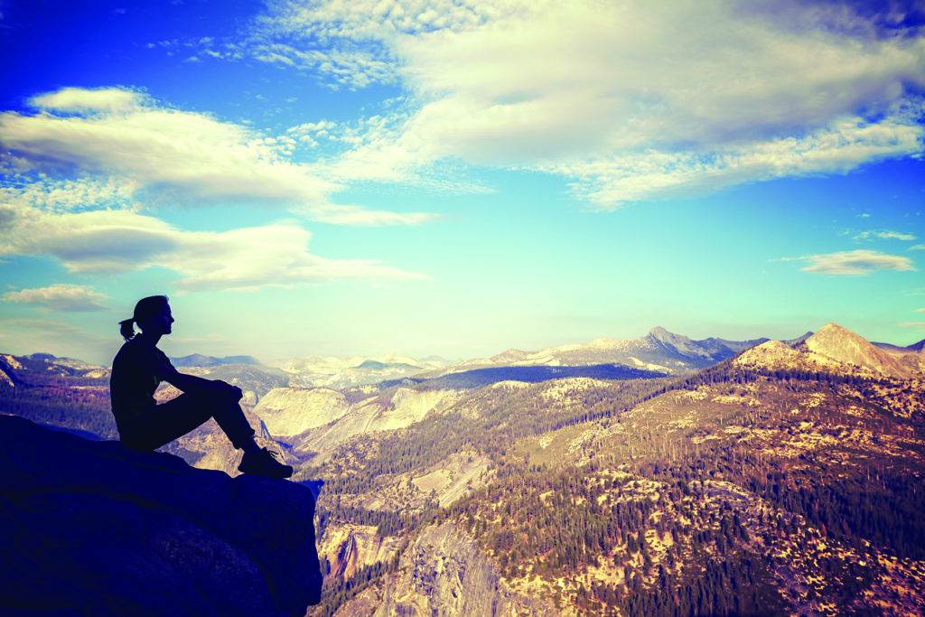 a man sitting on a rock