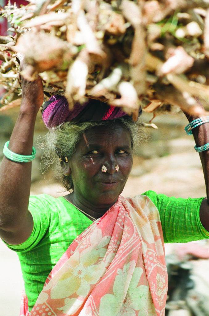 black woman is carrying something on her head