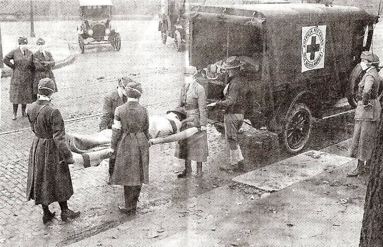 Red Cross workers remove a flu victim in St. Louis, Missouri (1918)