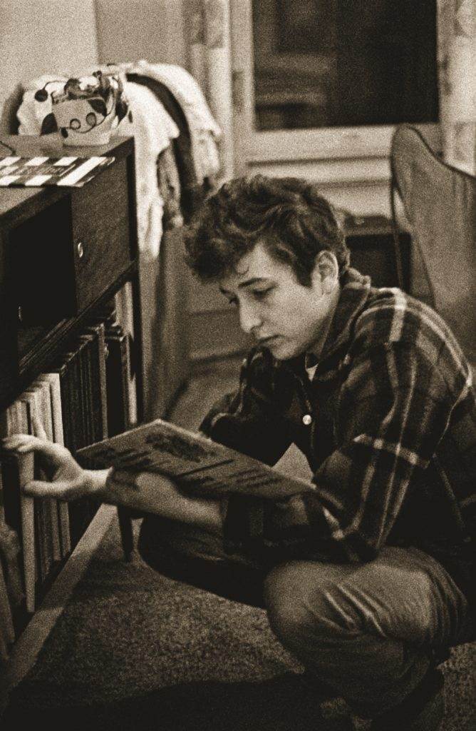 Bob Dylan examines a vinyl record