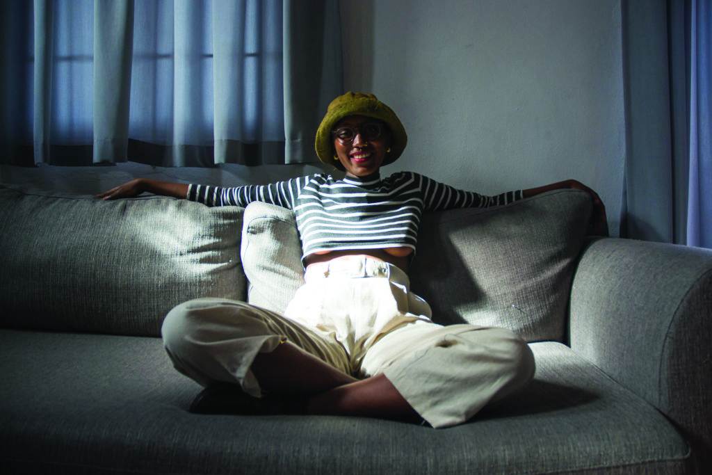 Smiling black woman on sofa