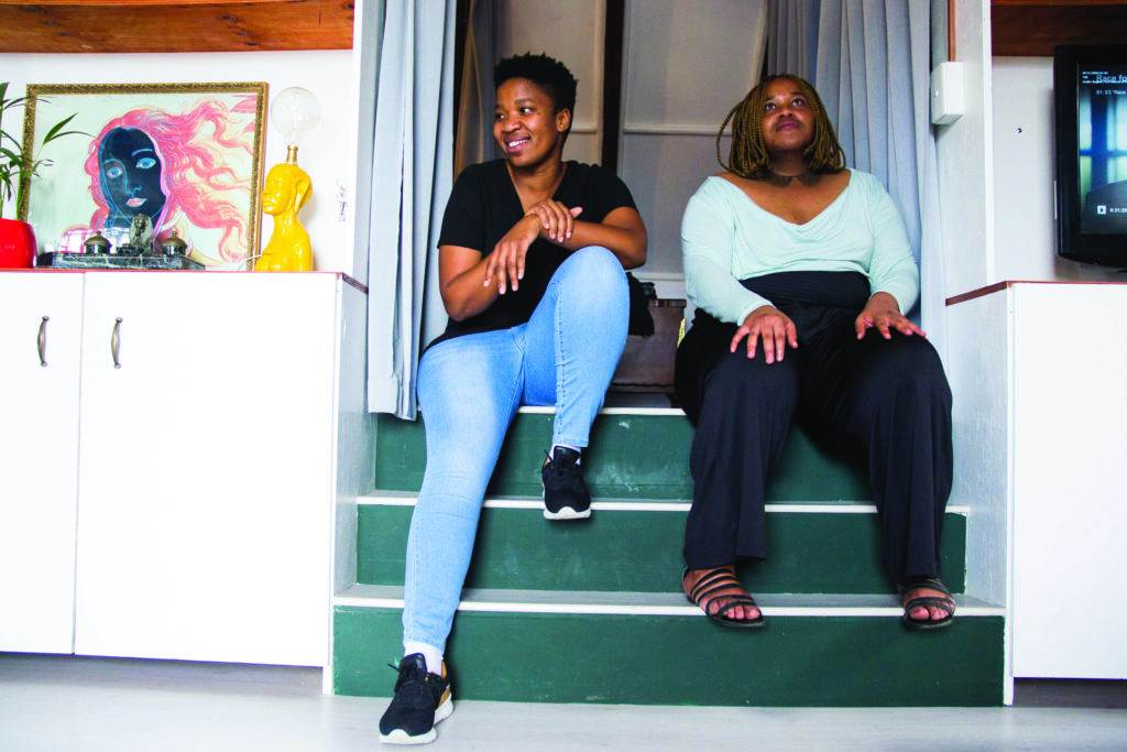 two women are sitting on the stairs