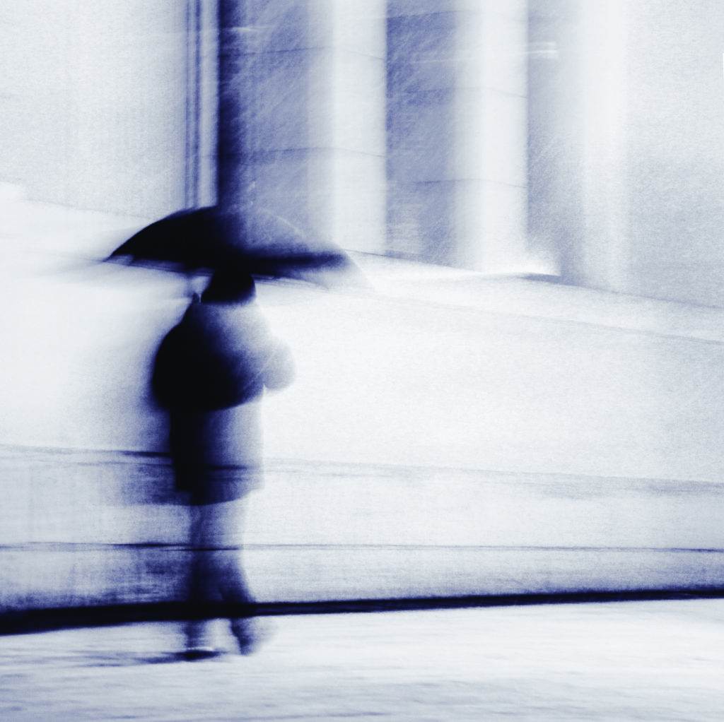 a man walking under an umbrella