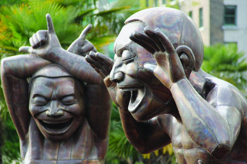 two statues with hands up