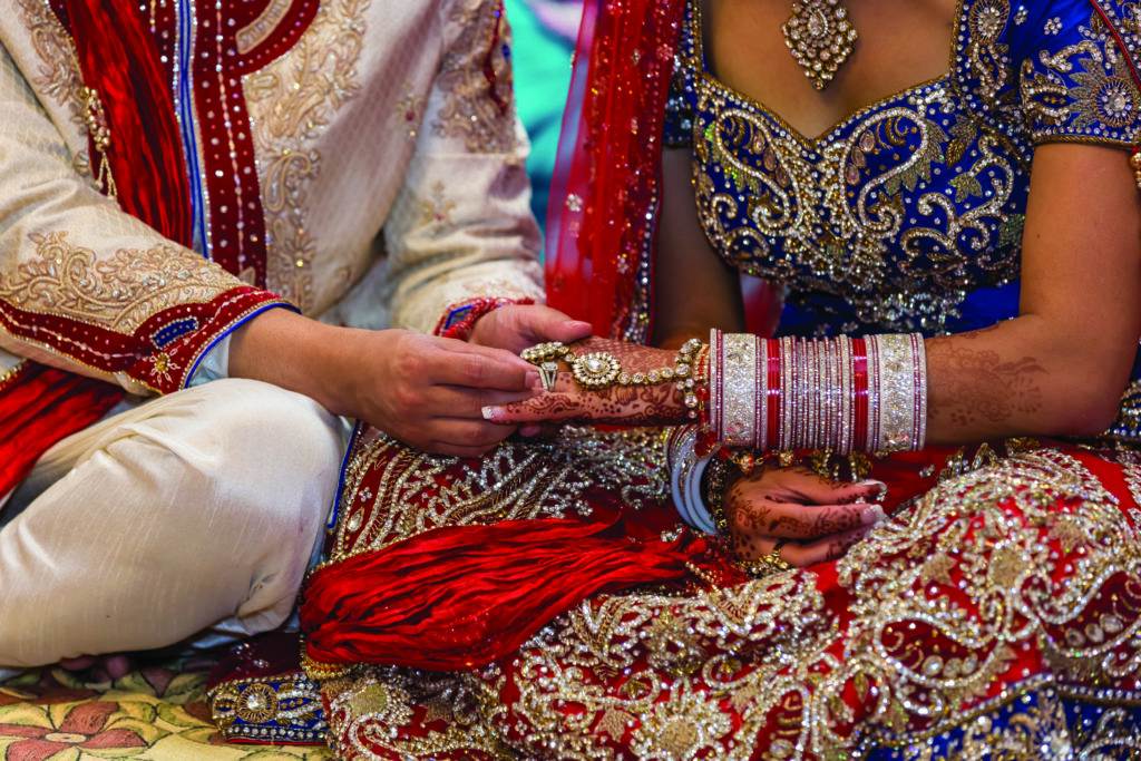 a man puts a ring on a woman's finger