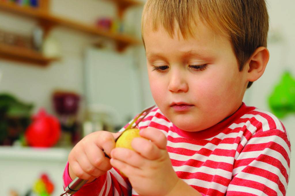 boy peeling potatoes