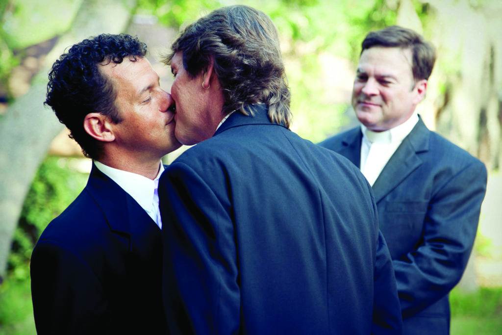 two men are kissing