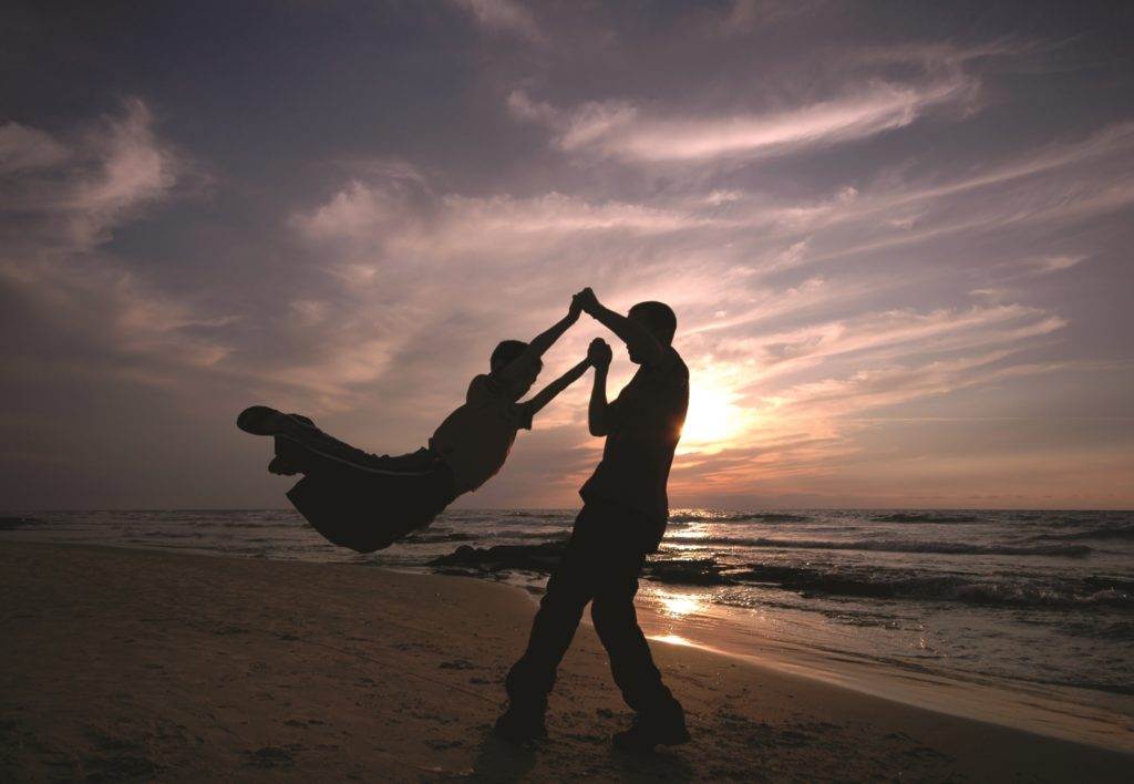 man and child near the sea