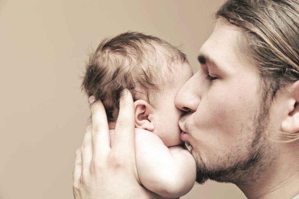 father kissing his child