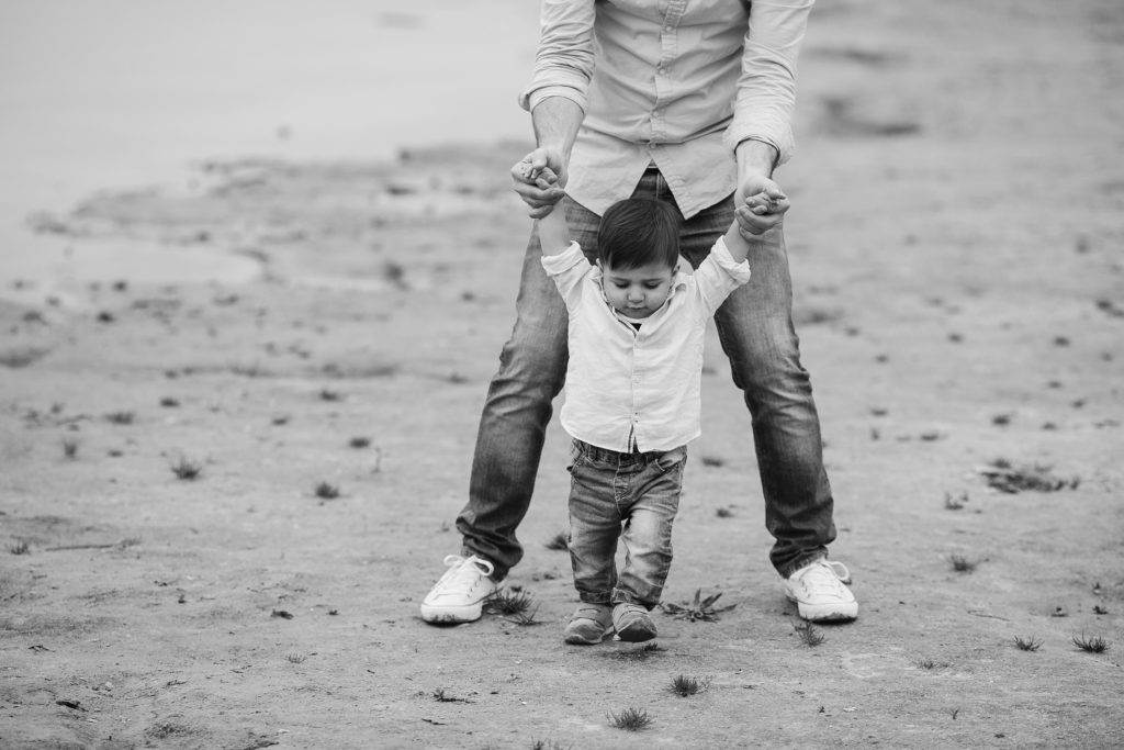 father teaches the child to walk