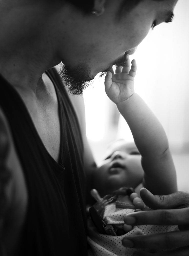 child touches father's lips