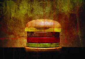 Abstract image of a burger with a grunge texture overlay, featuring vibrant red and yellow colors against a dark background and subtly hinting at Sneaky GMO themes.