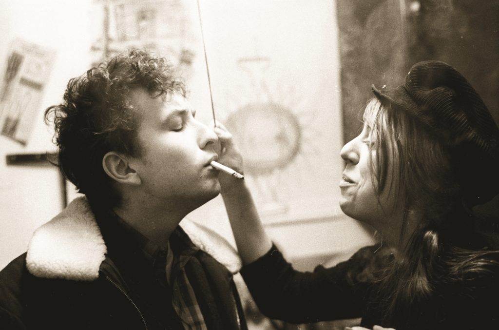 Bob Dylan is smoking and girl next ot him